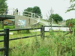 walkers across the bridge from estate to otherside of canal